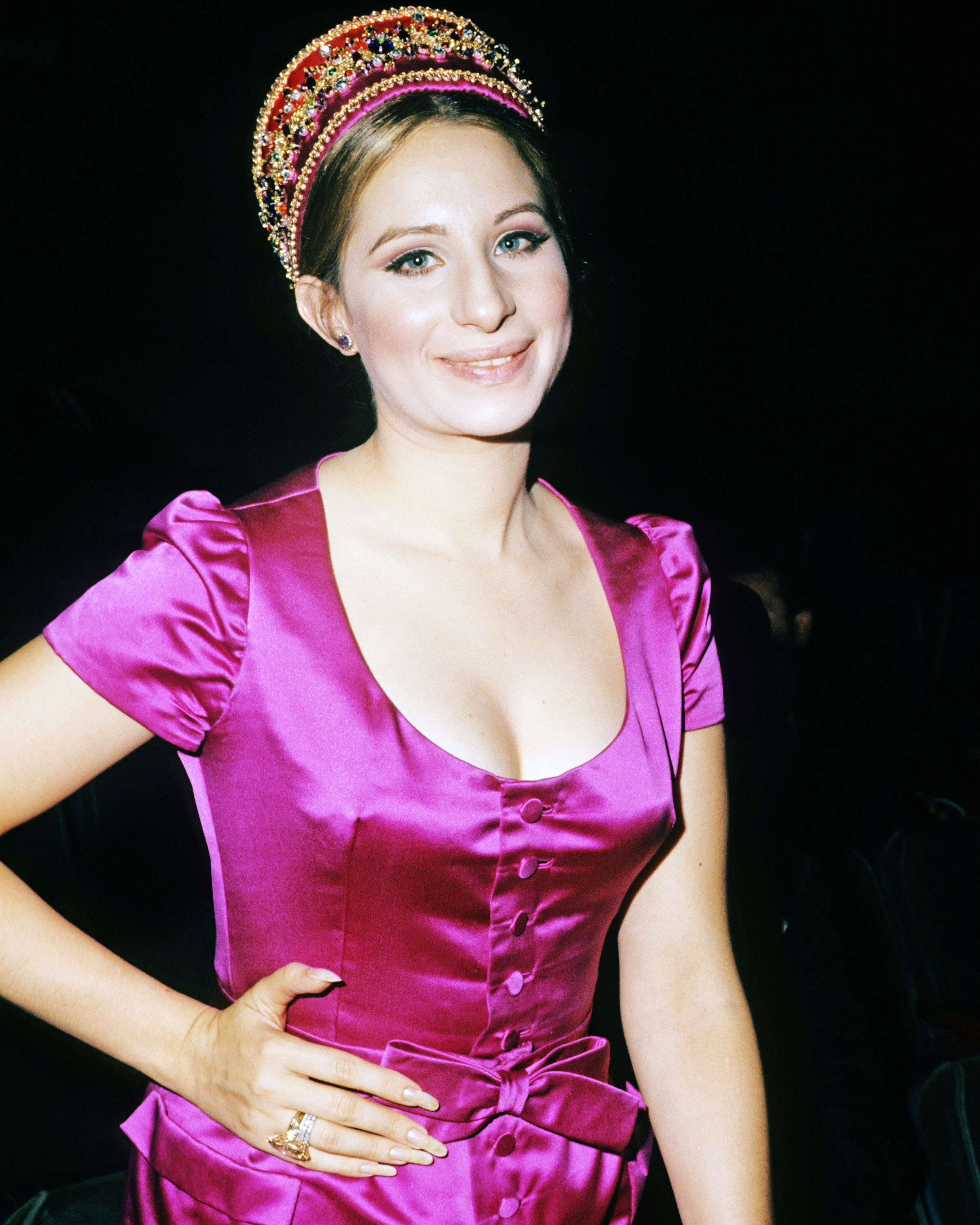 Barbra Streisand, US actress and singer, wearing a fuchsia pink silk dress with a scoop neckline and a matching bow around the waist, circa 1965. (Photo by Silver Screen Collection/Getty Images)