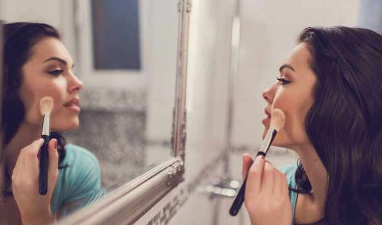 mulher-se-olhando-no-espelho-e-se-maquiando